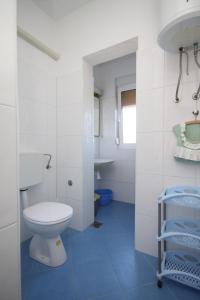 a white bathroom with a toilet and a sink at Apartments by the sea Slatine, Ciovo - 7544 in Slatine