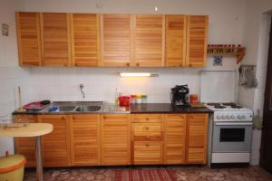 a kitchen with wooden cabinets and a sink and a stove at Seaside holiday house Razanj, Rogoznica - 7514 in Rogoznica +19 photos