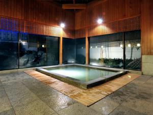 a swimming pool in the middle of a building at Hotel Hagoromo in Shizuoka