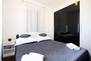 a bedroom with a large bed with two pillows at Apartments with a parking space Split - 7569 in Split