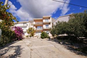 an empty street in front of a building at Apartments by the sea Duce, Omis - 7576 in Duće