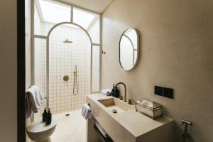 a bathroom with a sink and a mirror at Villa Lamer Canggu in Canggu +22 photos