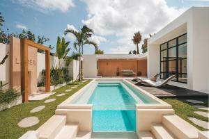 a swimming pool in the backyard of a house at Villa Lamer Canggu in Canggu
