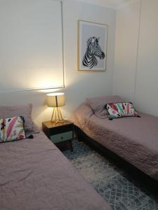 a bedroom with two beds and a picture of a zebra at Departamento en La Serena in La Serena