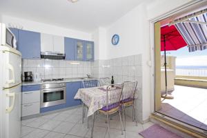 a kitchen with a table with a tablecloth on it at Apartments by the sea Split - 7589 in Split