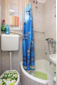 a bathroom with a toilet and a shower curtain at Apartments with WiFi Split - 7588 in Split