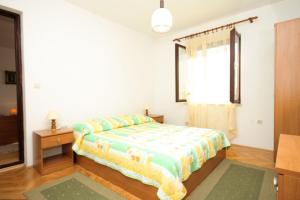 a bedroom with a bed and a window at Apartments with a parking space Peroj, Fazana - 7516 in Vodnjan