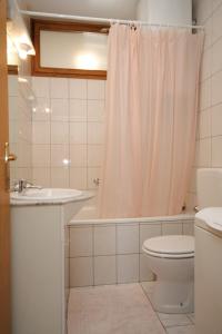 a bathroom with a toilet and a sink and a shower at Apartments with a parking space Peroj, Fazana - 7516 in Vodnjan