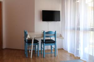 a dining room table with two chairs and a tv on the wall at Apartments with a parking space Vodice - 7604 in Vodice