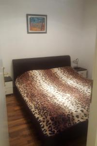 Ce lit se trouve dans une chambre dotée d'une couverture à motifs léopards. dans l'établissement Apartments with a parking space Novi Vinodolski - 7503, à Novi Vinodolski