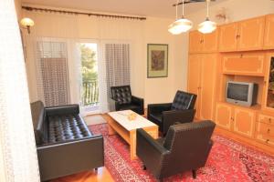 a living room with chairs and a table and a tv at Holiday apartments Pjescana Uvala, Pula - 7652 in Pula