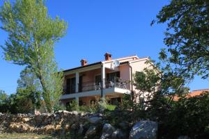 a house on top of a rock wall at Apartments with a parking space Presika, Labin - 7617 in Labin