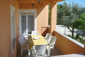 a table and chairs on the balcony of a house at Apartments with a parking space Pula - 7420 in Pula