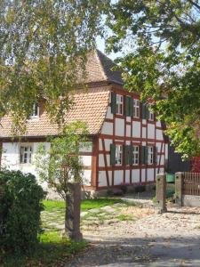a large house with a red and white building at Ickelhaus 2 in Bad Windsheim