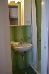 a bathroom with a sink and a mirror at Apartments with parking space Rab - 12383 in Rab
