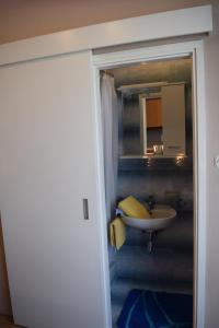 a bathroom with a sink and a mirror at Apartments with parking space Rab - 12383 in Rab