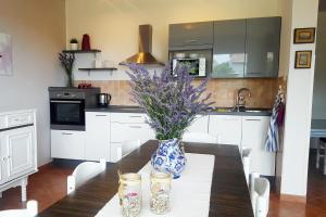 a kitchen with a table with a blue and white vase on it at Apartments with parking space Rab - 12383 in Rab +21 photos