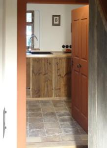 a kitchen with wooden cabinets and a sink at Ickelhaus 2 in Bad Windsheim