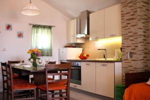 uma cozinha e sala de jantar com mesa e cadeiras em Family friendly house with a swimming pool Vinisce, Trogir - 7510 em Vinišće