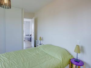um quarto com uma cama verde e um espelho em Appartement Saint-Jean-de-Luz, 2 pièces, 4 personnes - FR-1-4-646 em Saint-Jean-de-Luz