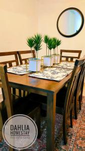 a dining room table with potted plants on it at Dahlia Homestay Putrajaya in Putrajaya