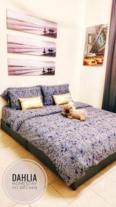 a dog laying on a bed in a room at Dahlia Homestay Putrajaya in Putrajaya