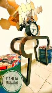 a clock sitting on top of a table at Dahlia Homestay Putrajaya in Putrajaya