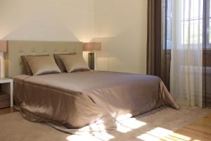a bedroom with a large bed in a room at Casa de Cambres in Lamego