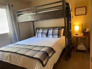 a bedroom with a bed with a wooden bunk bed at DAS BAVARIAN CONDO, 5 Star Ground Floor Unit, Walk to Town, Sleeps 6 in Leavenworth