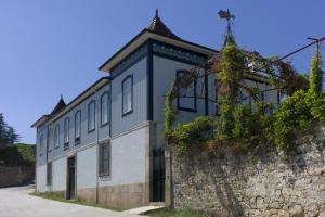 an old building next to a stone wall at Casa de Cambres in Lamego