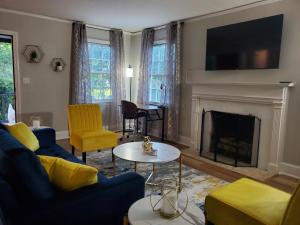a living room with a couch and a fireplace at Cheerful 2 BR Near Colleges, Downtown, Attractions in Montgomery