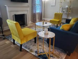 a living room with a couch and chairs and a fireplace at Cheerful 2 BR Near Colleges, Downtown, Attractions in Montgomery
