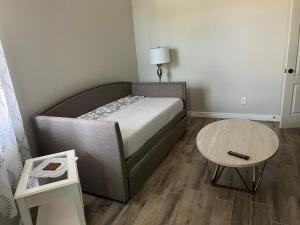 a small bedroom with a bed and a table at Queen creek az casita in Queen Creek