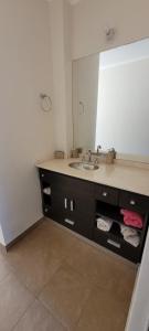 a bathroom with a sink and a mirror at Dúplex amplio y luminoso in San Fernando del Valle de Catamarca