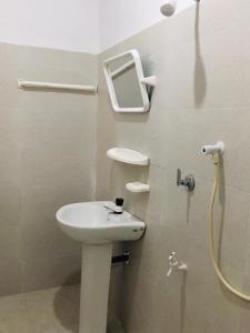 a bathroom with a sink and a shower at Sujeewa Holiday Resort Anuradhapura in Anuradhapura