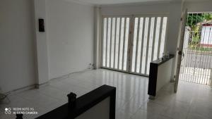 a room with white tile floors and sliding glass doors at Agradable casa para una excelente estadía. in Palmira