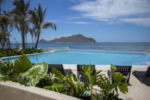 a swimming pool with a view of the ocean at Viaggio Resort Mazatlán in Mazatlán