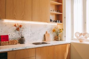 a kitchen counter with a sink and a window at Village Aparthotel By BOA in Porto