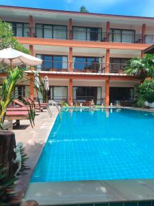 a swimming pool in front of a hotel at Grand Thai House Resort in Lamai