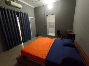 Postel nebo postele na pokoji v ubytování Nathaniela Family Homestay