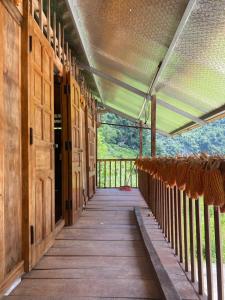 an inside view of a wooden porch with a door at Tuệ Nhi Homestay Ngườm Ngao Bản Giốc in Cao Bằng