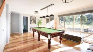 a living room with a pool table in it at Phoenix in Hepburn