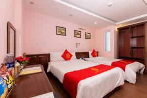 Postel nebo postele na pokoji v ubytování London Sa Pa Hotel