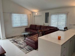 a living room with a couch and a table at Joy Estate Rooftop Pool n View unit #1 in Falmouth