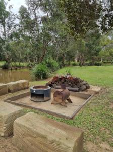 a fire pit in a park next to a field at Nomads Rest in Gympie