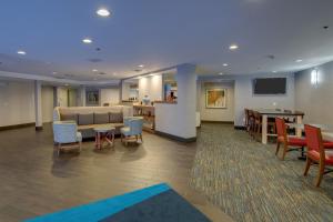 a lobby with a couch and a table and chairs at Holiday Inn Express Nashville W-I40, an IHG Hotel in Nashville
