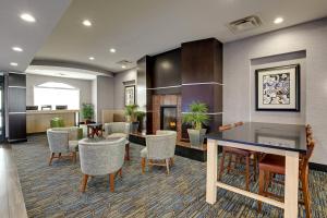 a lobby with chairs and a table in a room at Holiday Inn Express Nashville-Opryland, an IHG Hotel in Nashville