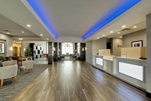 an empty lobby with a blue ceiling at Holiday Inn Express Nashville-Opryland by IHG in Nashville +38 photos
