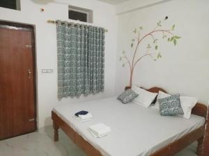 a room with a bed with a tree on it at Cocoon Auberge in Jaipur +43 photos