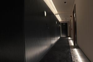 an empty hallway with lights on the wall at Letoh Letoh Gran Vía in Madrid +53 photos